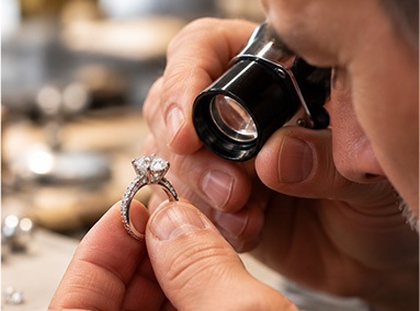 Jeweler examining a ring through a loupe